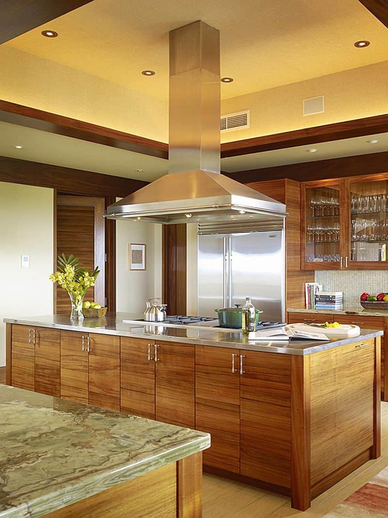 Pecan Cabinets with golden walls and olive marble