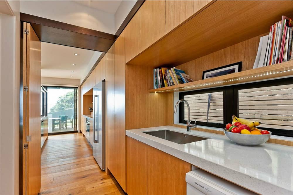 Wooden cabinetry complement the flooring
