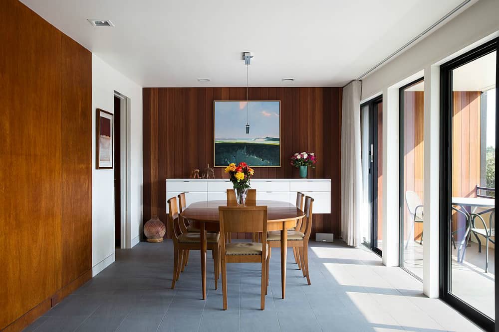 Beautiful dining room is set close to glazed balcony doors to enjoy plenty of natural light