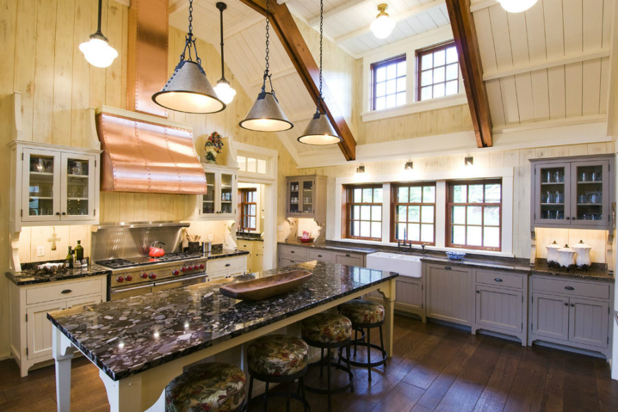 Kitchen with ceiling beams and a copper hood