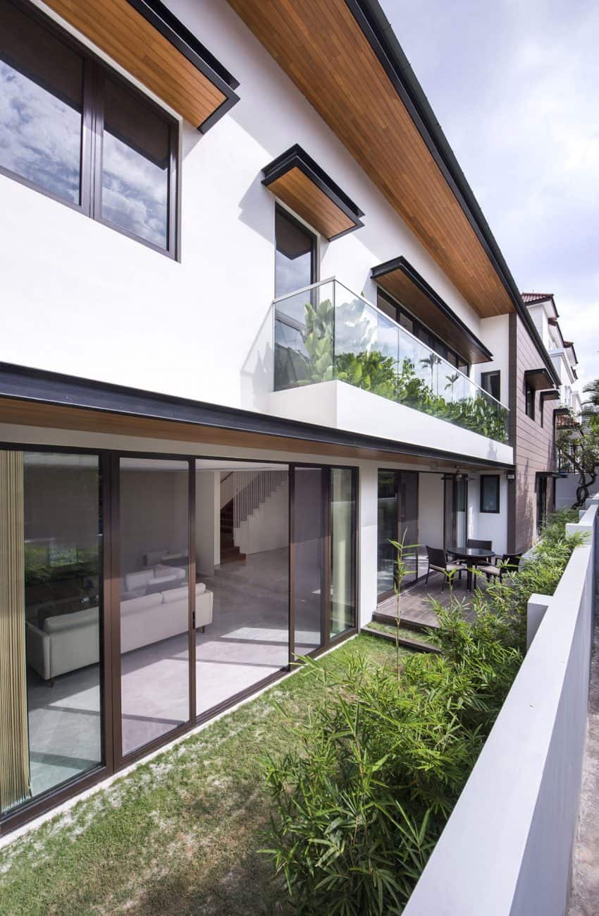 Glass balcony railing shows off a surprising greenery patch This 30 Year Old Modernized House in Singapore Looks Like New