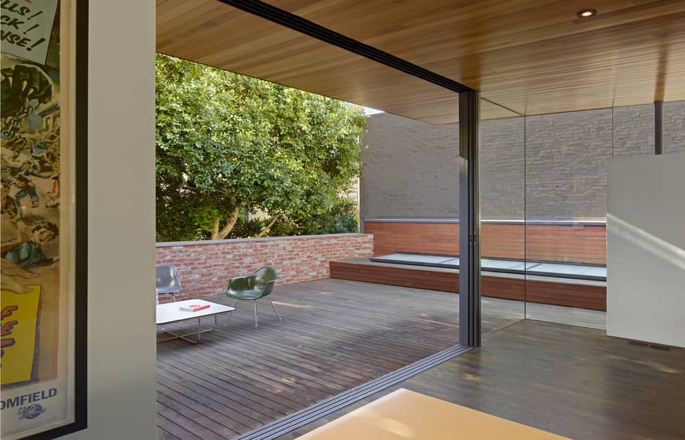 Indoor-outdoor room opens up to the wooden terrace