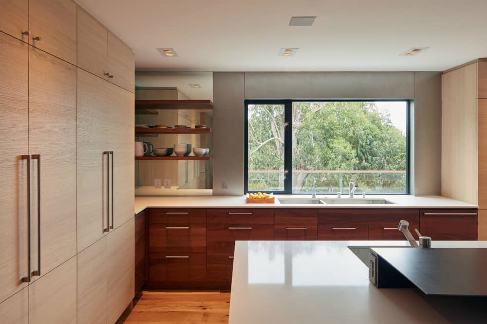 Kitchen features a huge window and plenty of storage space