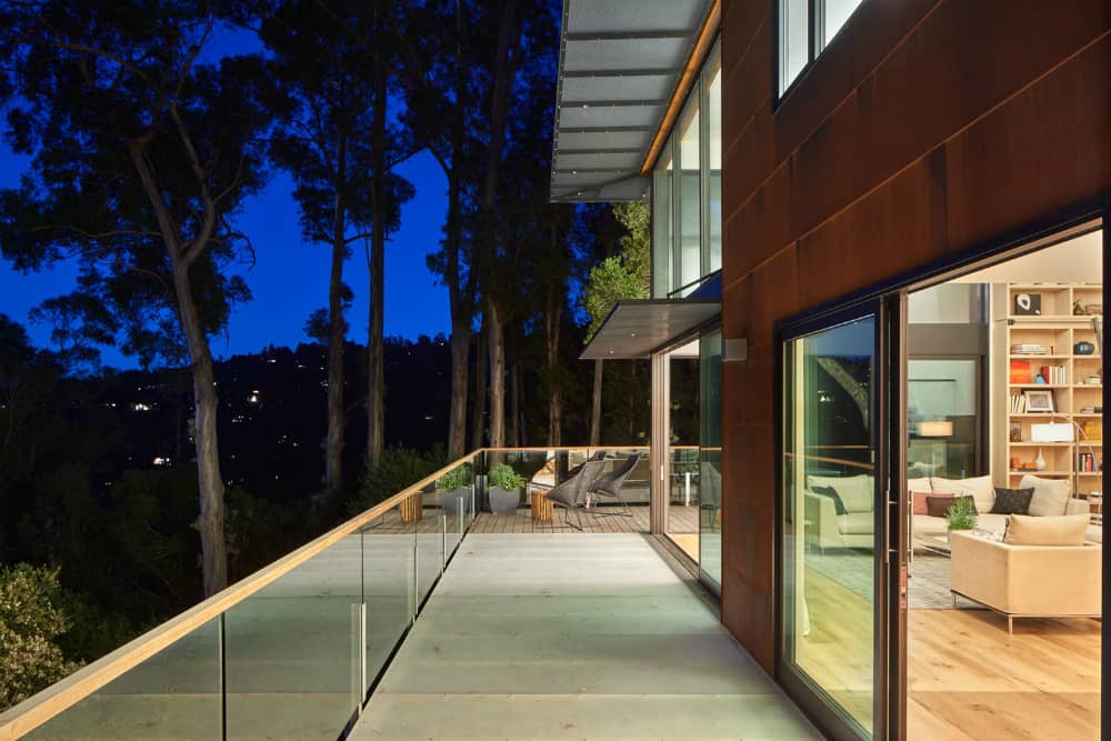 Top level balcony’s glass railings allow unobstructed views of the green locale
