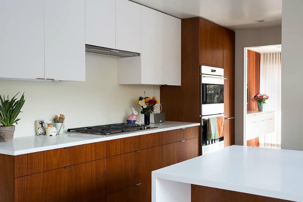 White kitchen countertops contrast nicely with wooden cabinets