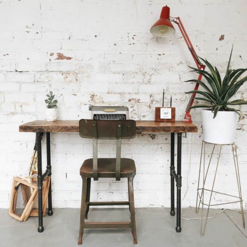 Tall writing desk with reclaimed wood on top and pipes