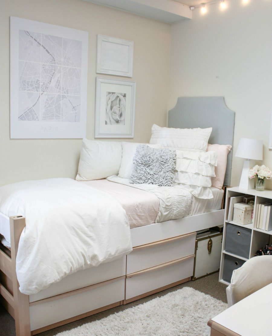 Neutral dorm room with a high bed frame