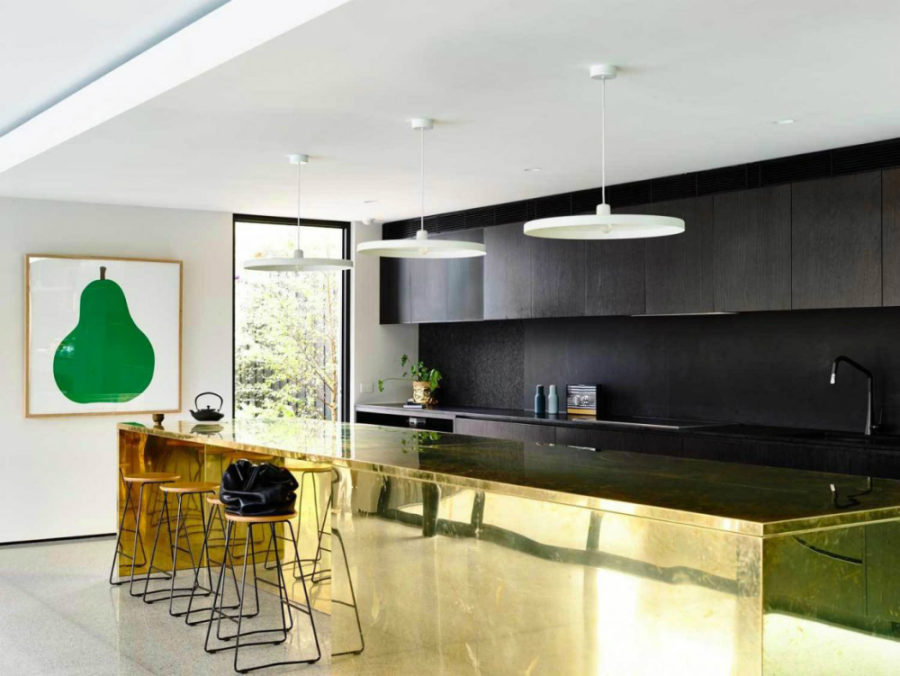 Contemporary kitchen with black cabinets and golden kitchen island