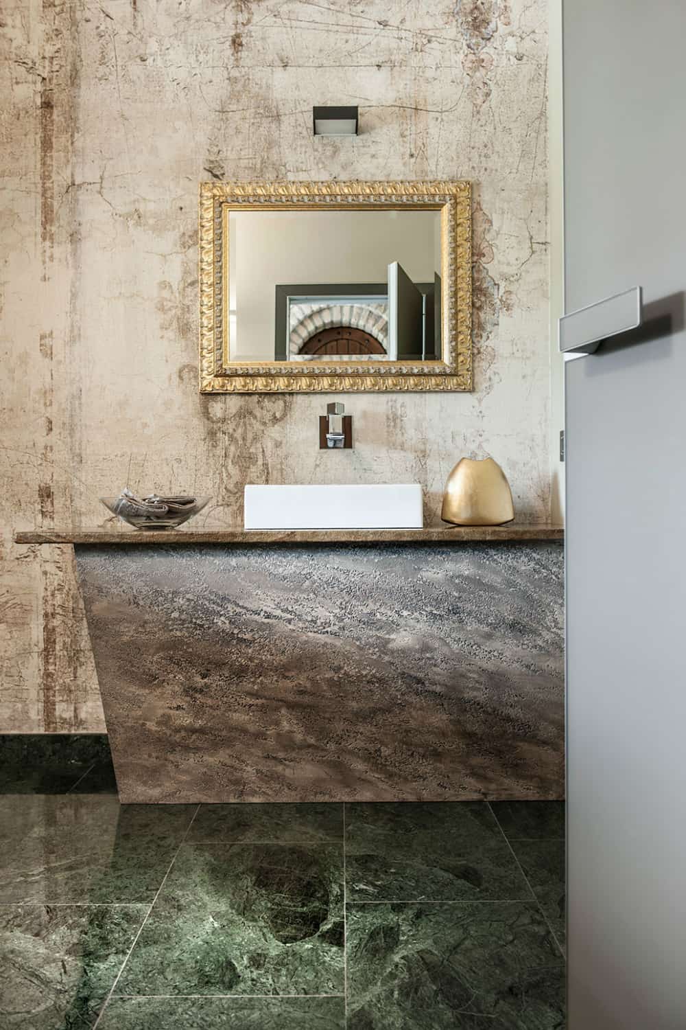 Golden accents work well with the textured stone surfaces