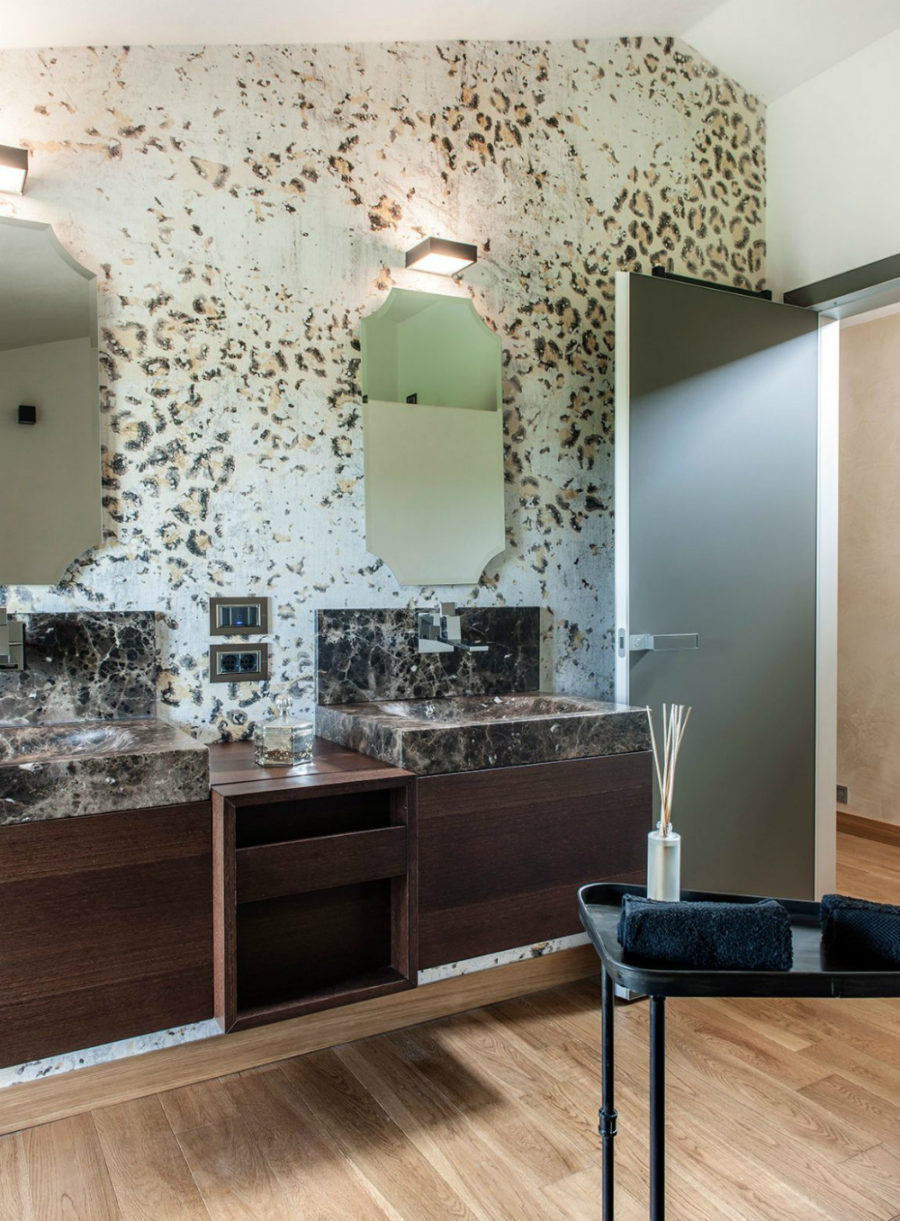 Marble sinks play along the cheetah-patterned walls