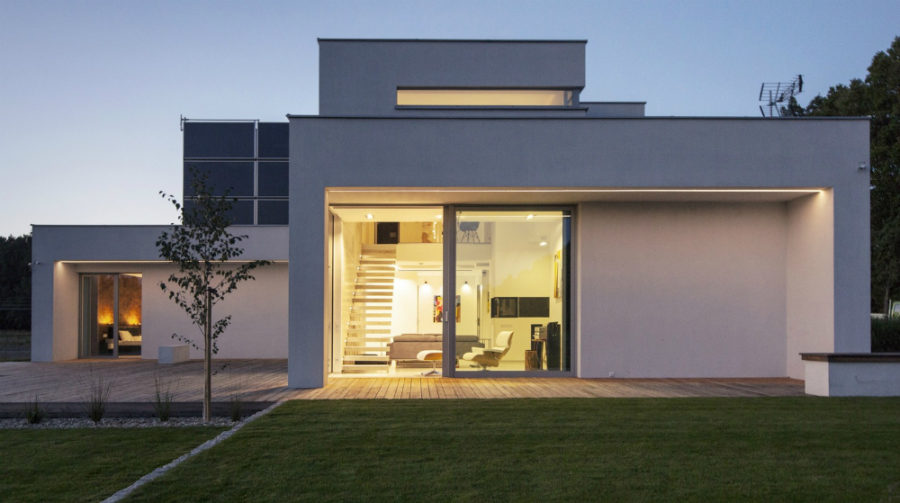 Yellow lighting gives warmth to the white concrete abode