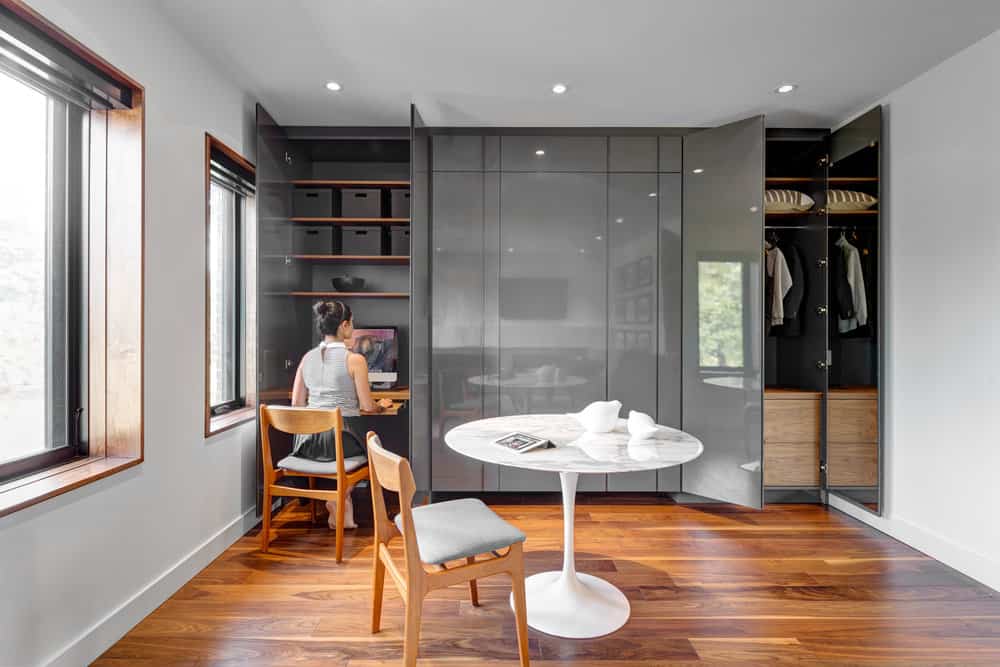 A sleek glossy closet hides a home office