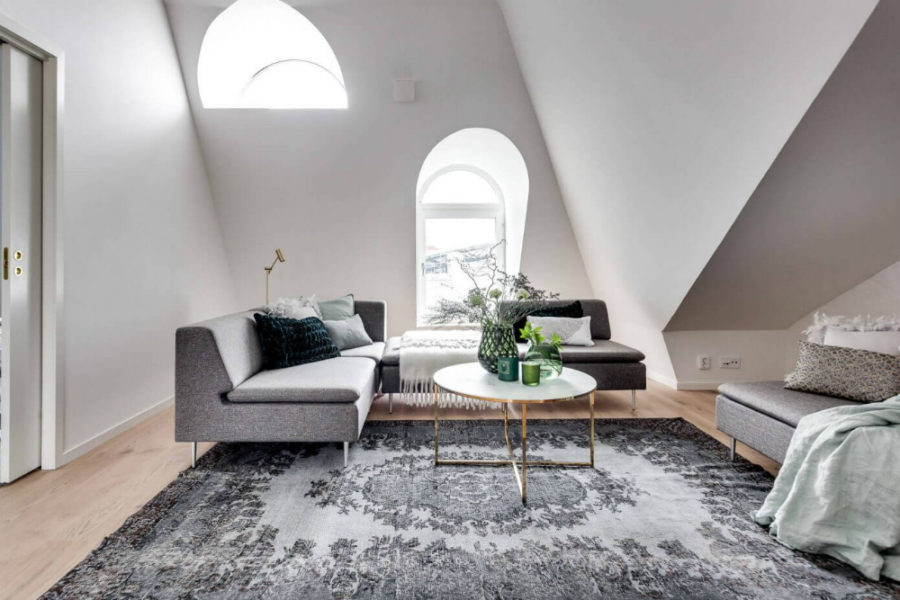 Arched windows flood the white living room with light