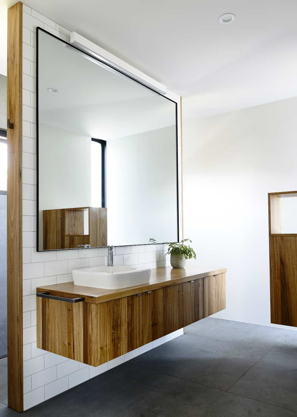 Bathroom vanity made of same wood as the kitchen