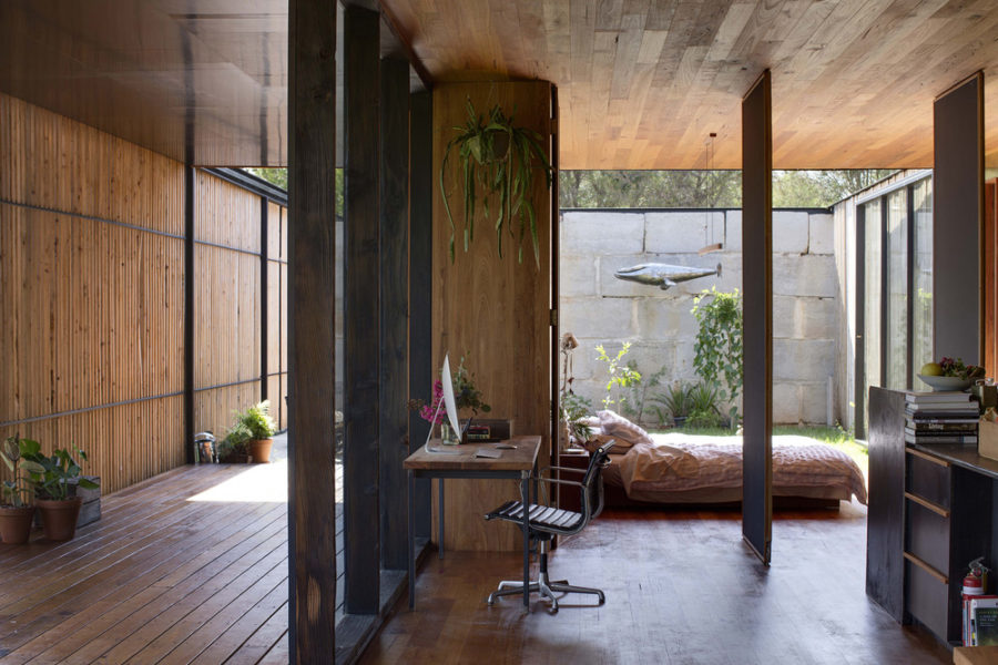 Bedroom located right behind the working area opens to both inner courtyard and the living room with pivoting walls