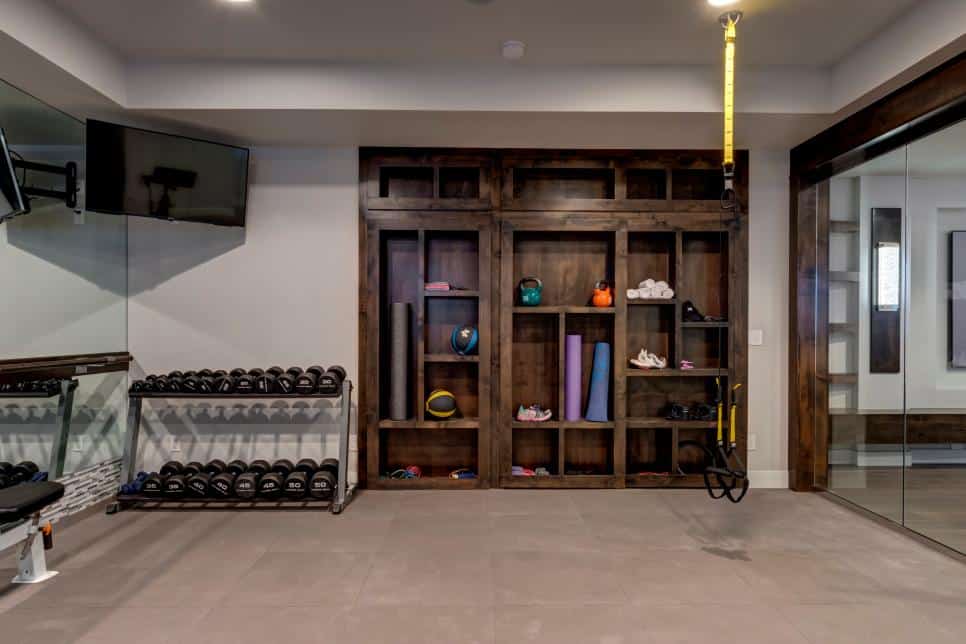 Highly organized gym by Finished Basement Company