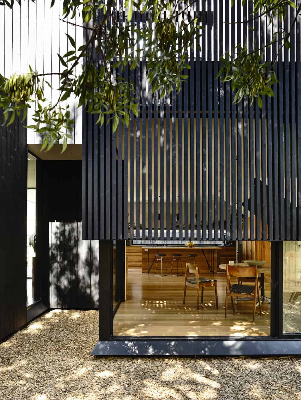 House's glass features get light and privacy from wooden screen layer