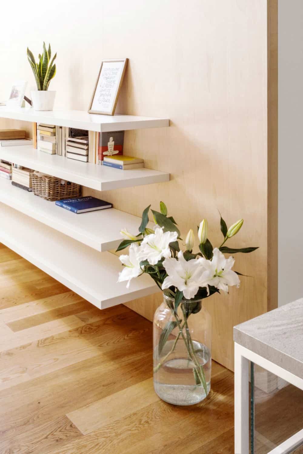 Open shelving provides storage for a home office across the seating room