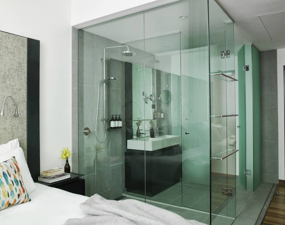 Room with a glass-enclosed bathroom