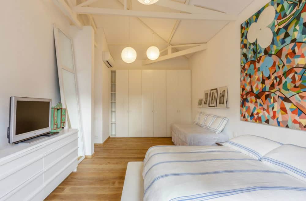 Spacious bedroom comes with a built-in closet and cool ceiling beams
