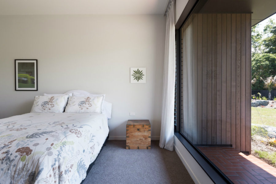 The bedroom too opens to the outdoors with a huge window