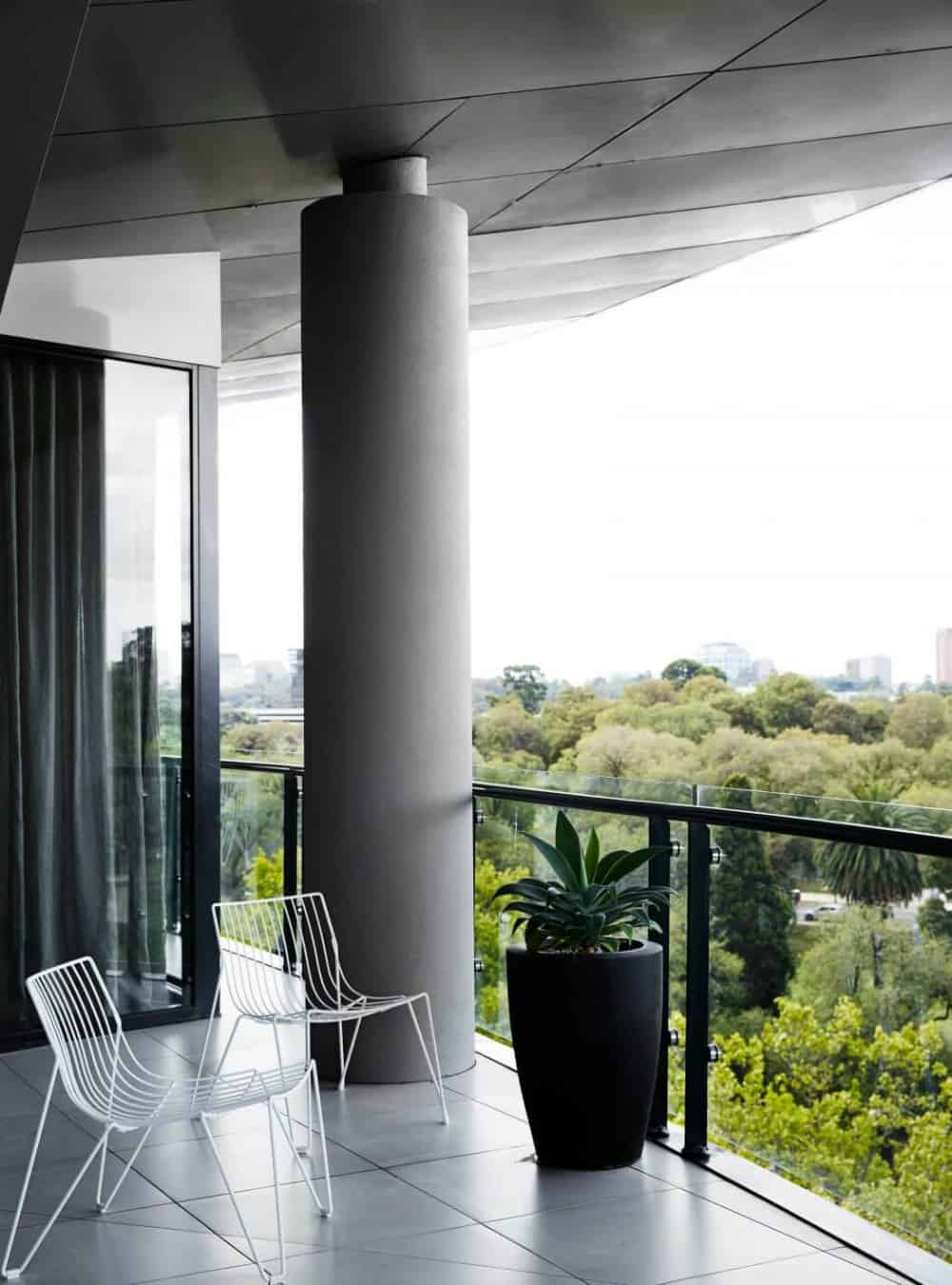 A balcony with a grand column opens up to great views