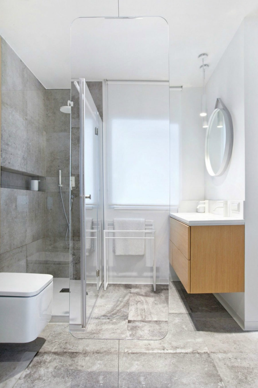 A rounded angle glass divider demarcates areas in the bathroom