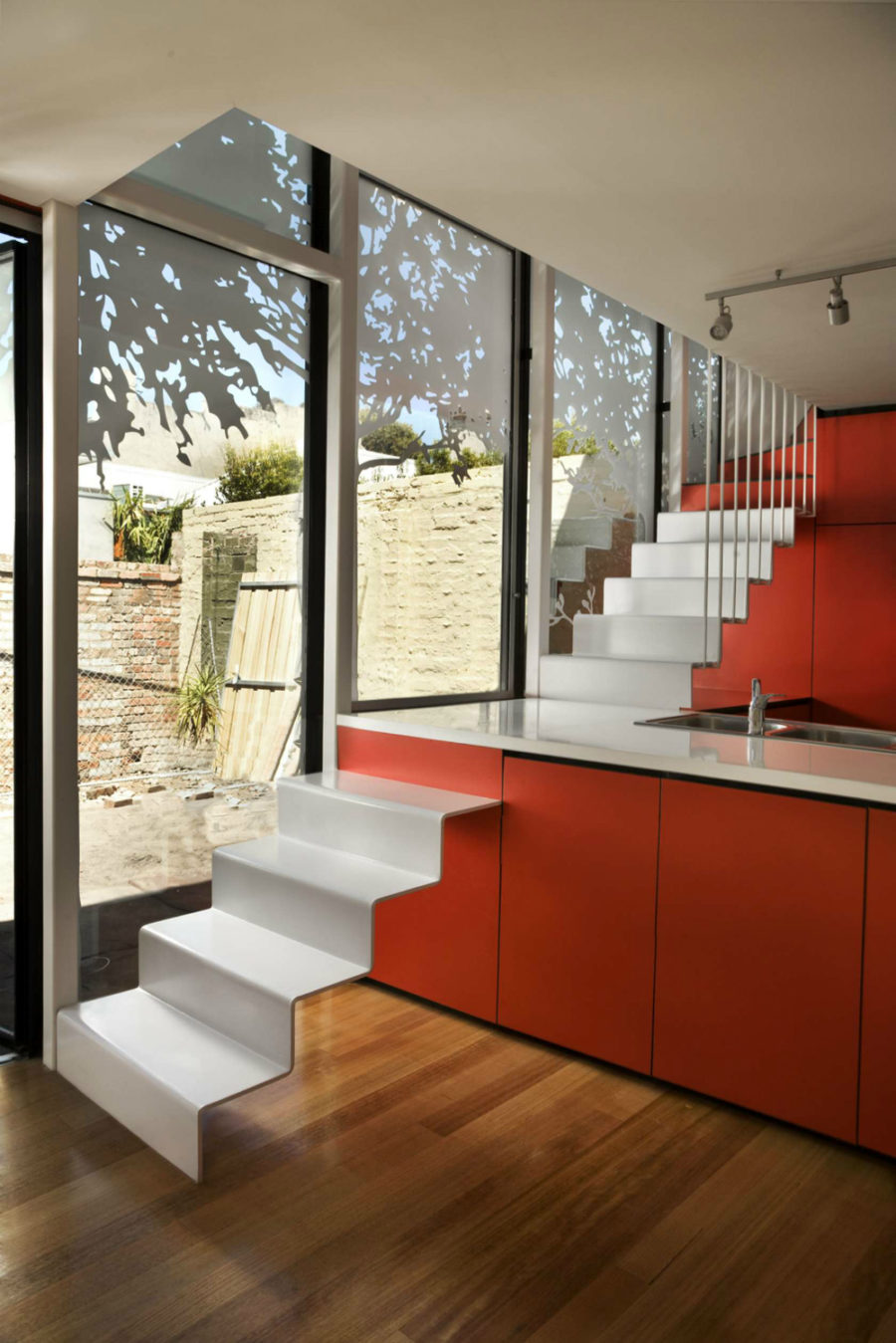 Andrew Maynard Architects put a staircase through the kitchen island