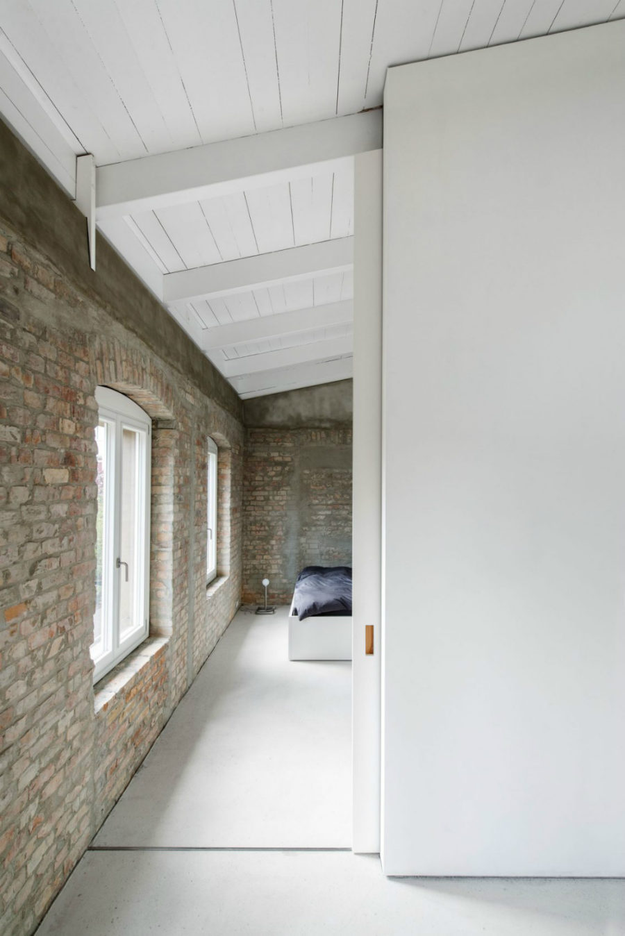 Bedroom has the same exposed brick walls