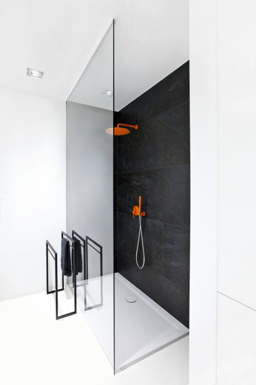 Black shower wall works beautifully with white floors and interior