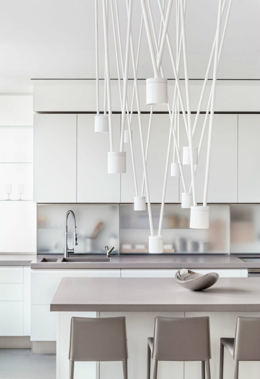 Contemporary lights add plenty of dynamic to the minimal kitchen