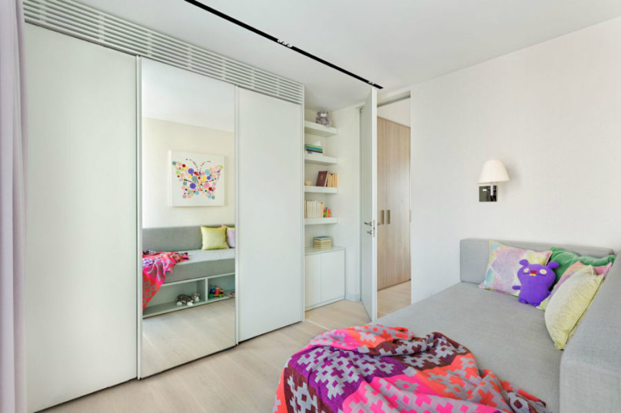Kids bedroom is contemporarily minimal but not without bright splashes of color
