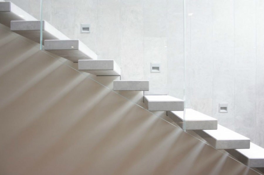 Modern staircase has safety lights built into the wall every three steps