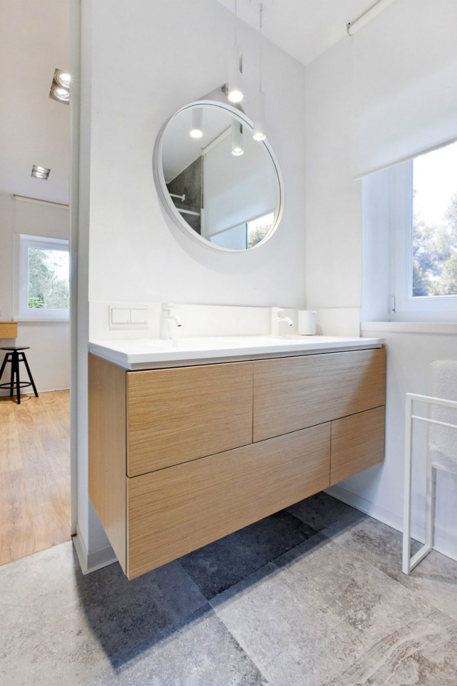 Modest bathroom echoes the kitchen with white hardware