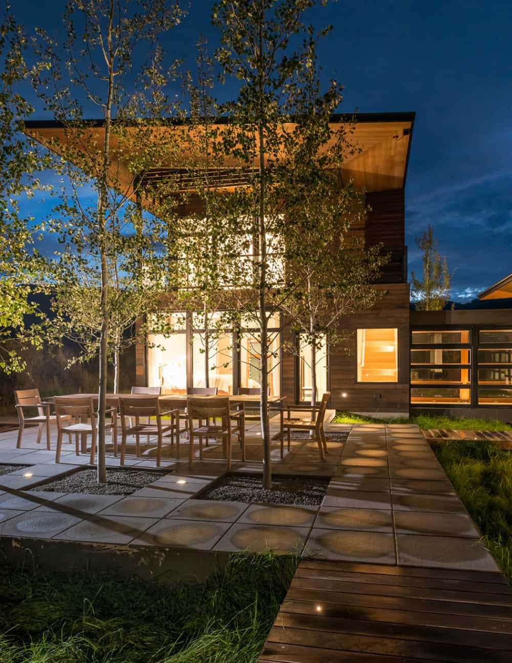 Outdoor dining room gets illlumination from numerous windows in the evening