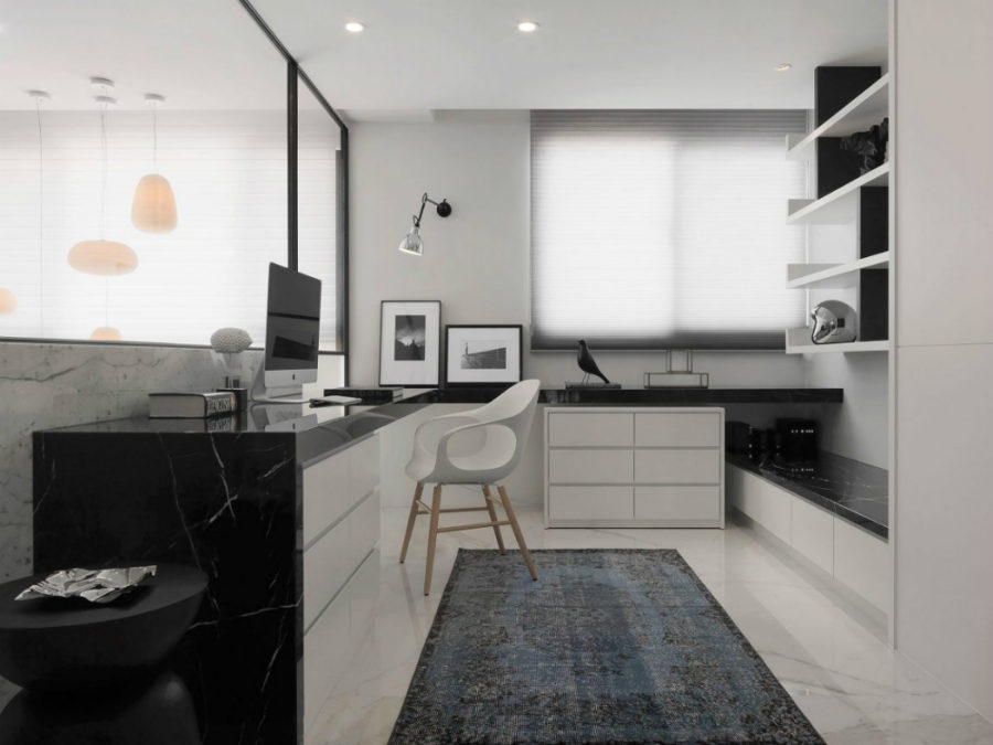 Stylish home office features black marble tabletops