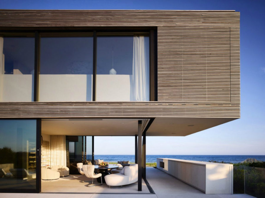 The glass-encased living area has views of the ocean
