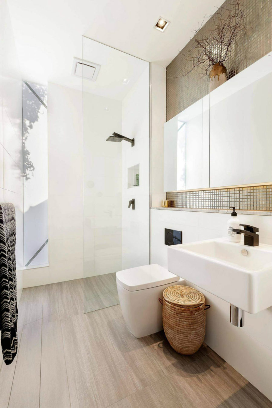 The shower features a glazed inclusion that opens up the space to outdoors