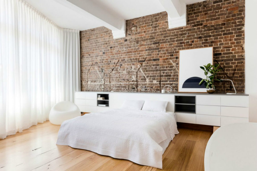 White apartment contrasts with old exposed brick