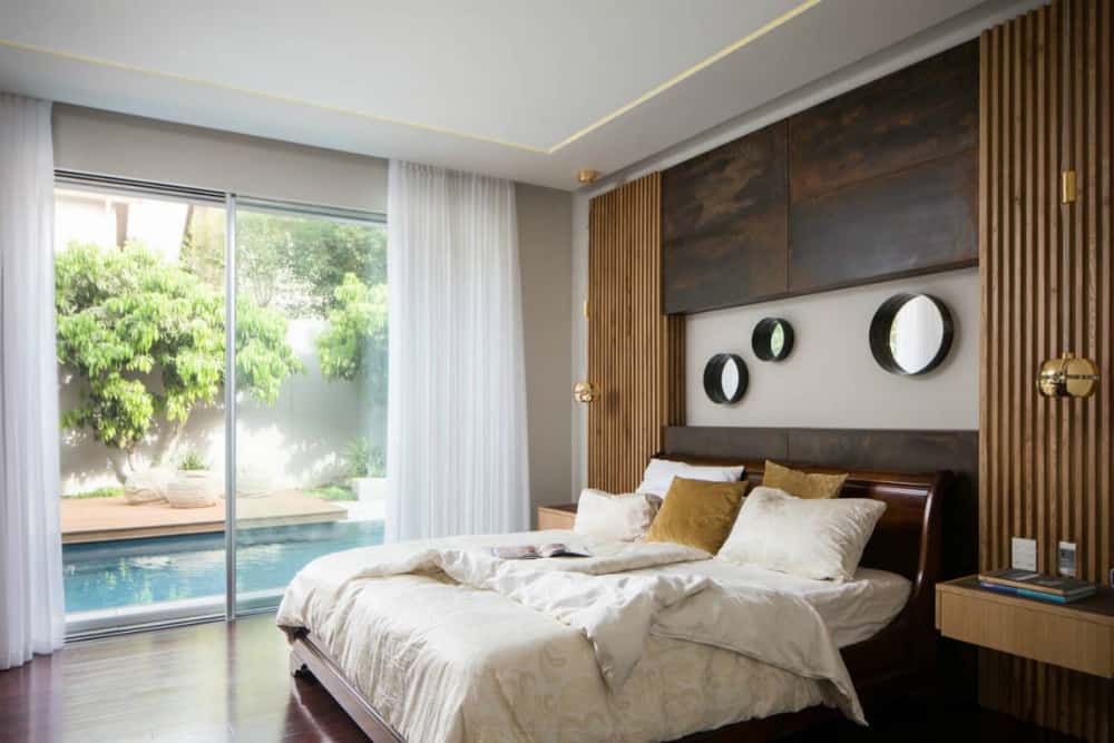 Bedroom with swimming pool access boasts an interesting feature wall design