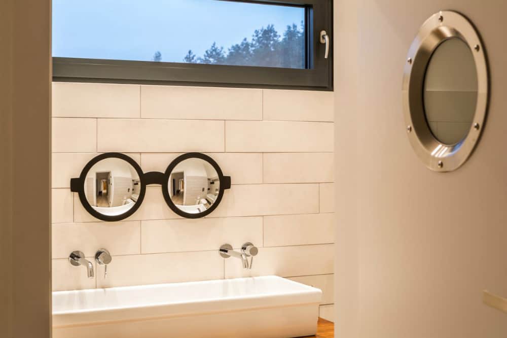 Glasses-shaped bathroom mirror is a playful detail for kids bath