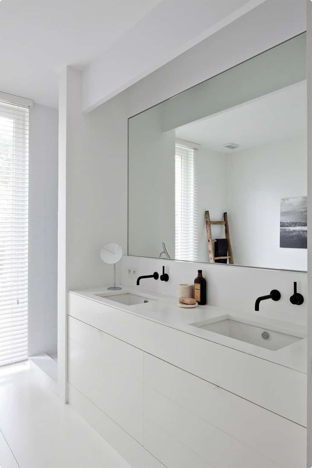White bathroom with a big mirror