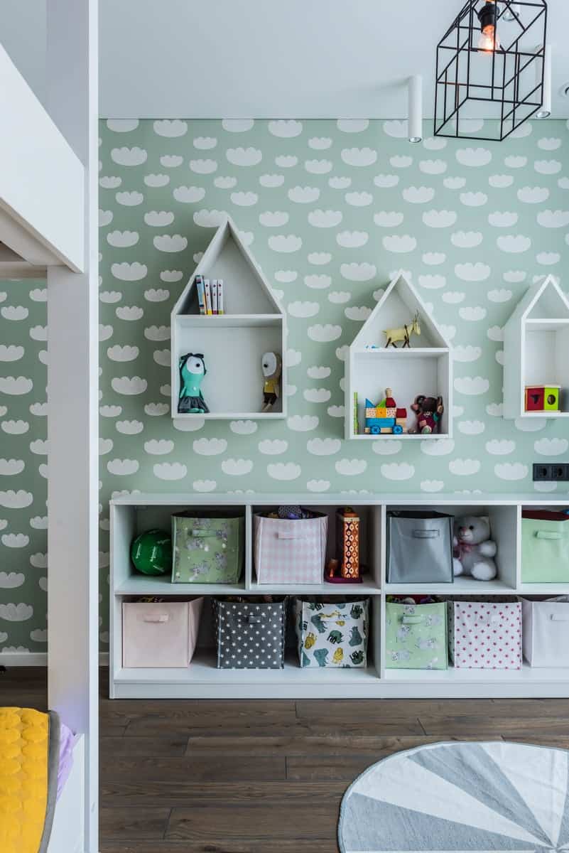 A playful patterned wallpaper sets the mint scheme for the room