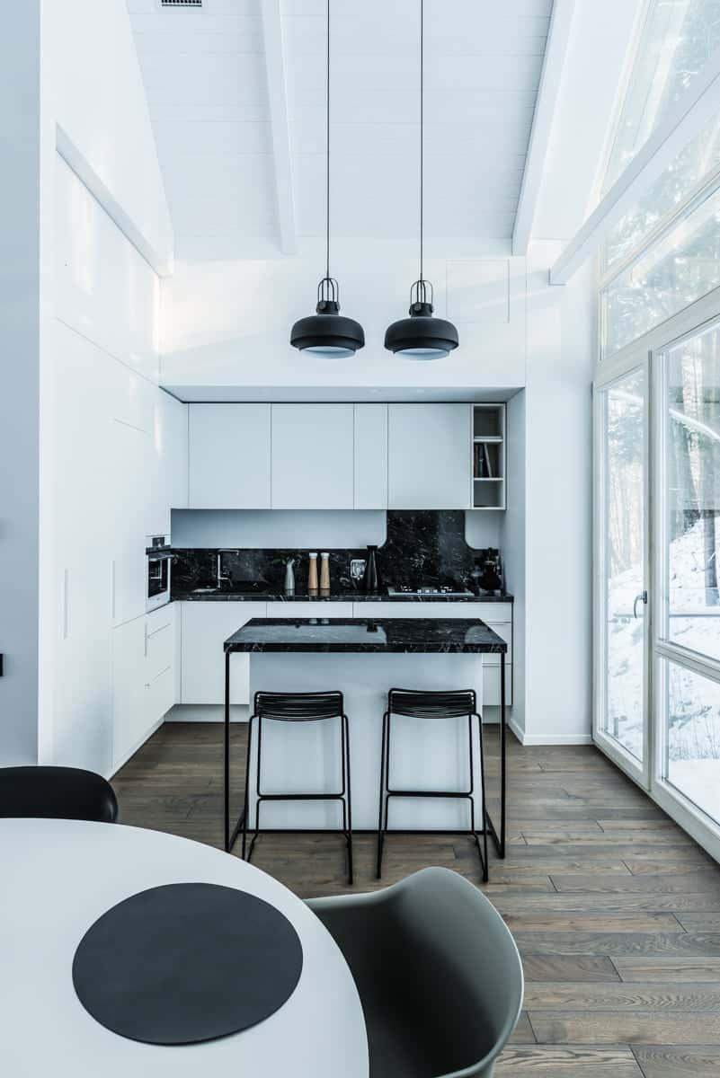 Small corner kitchen boasts a two-seater breakfast bar