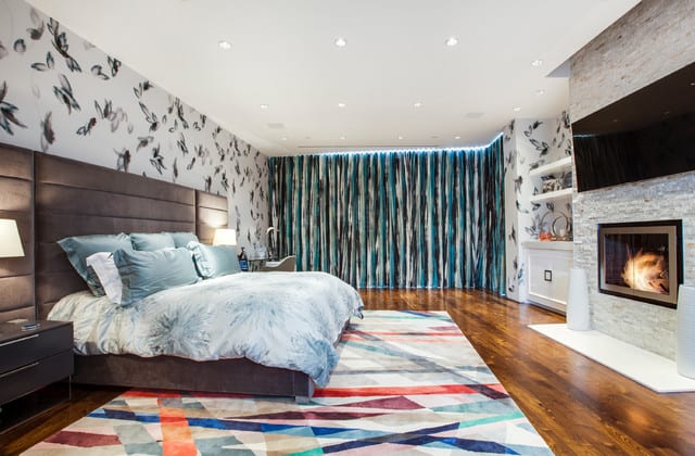 Contemporary bedroomw ith colorful geometric carpet