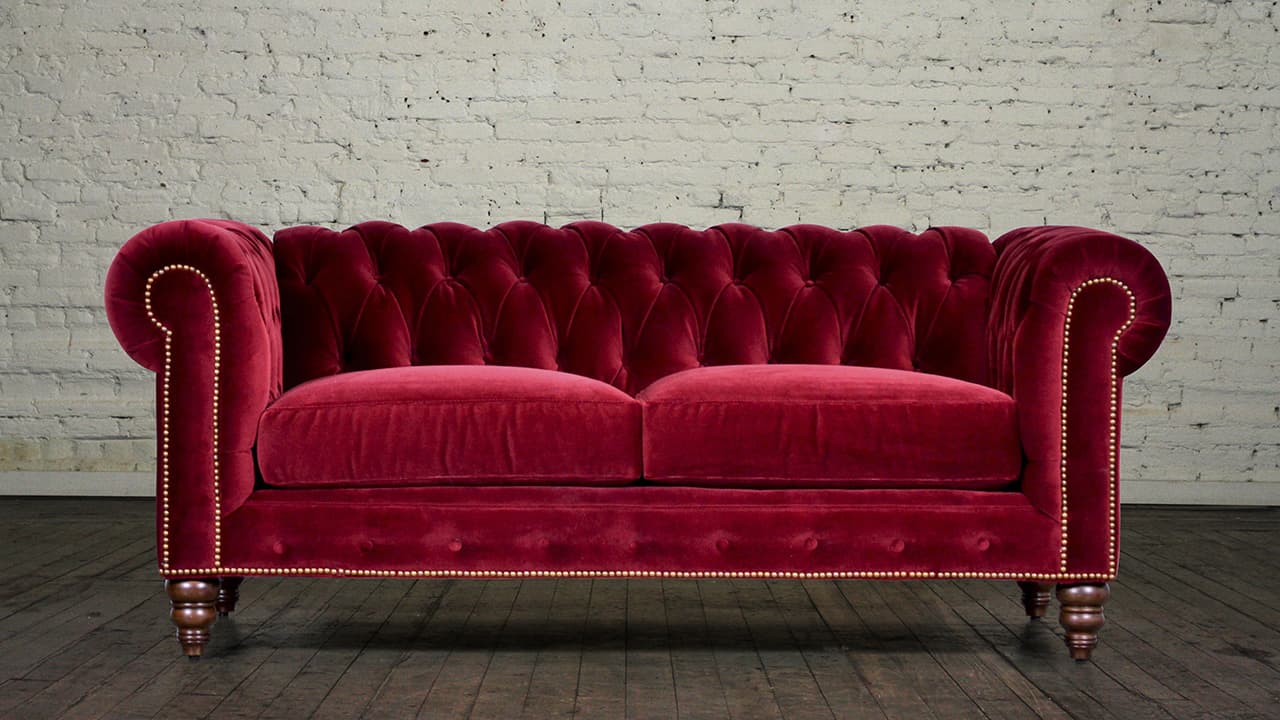 red velvet tufted sofa