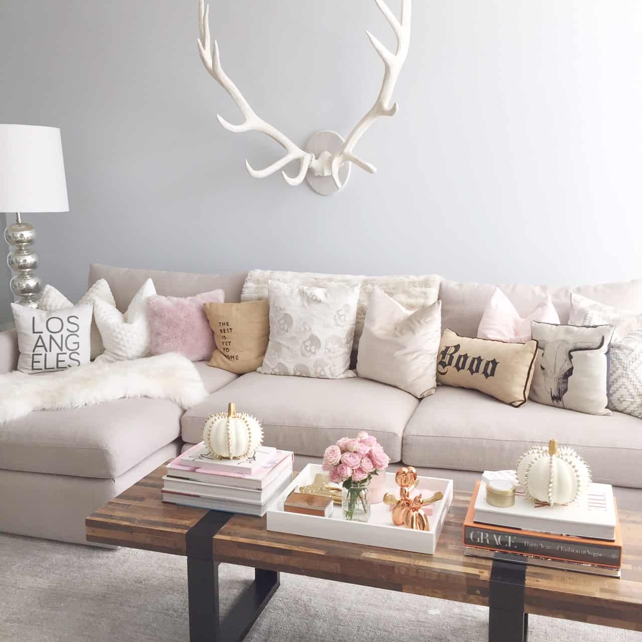 Combine white chic antlers with a faded wooden center table to offset the intricate style of the antlers.