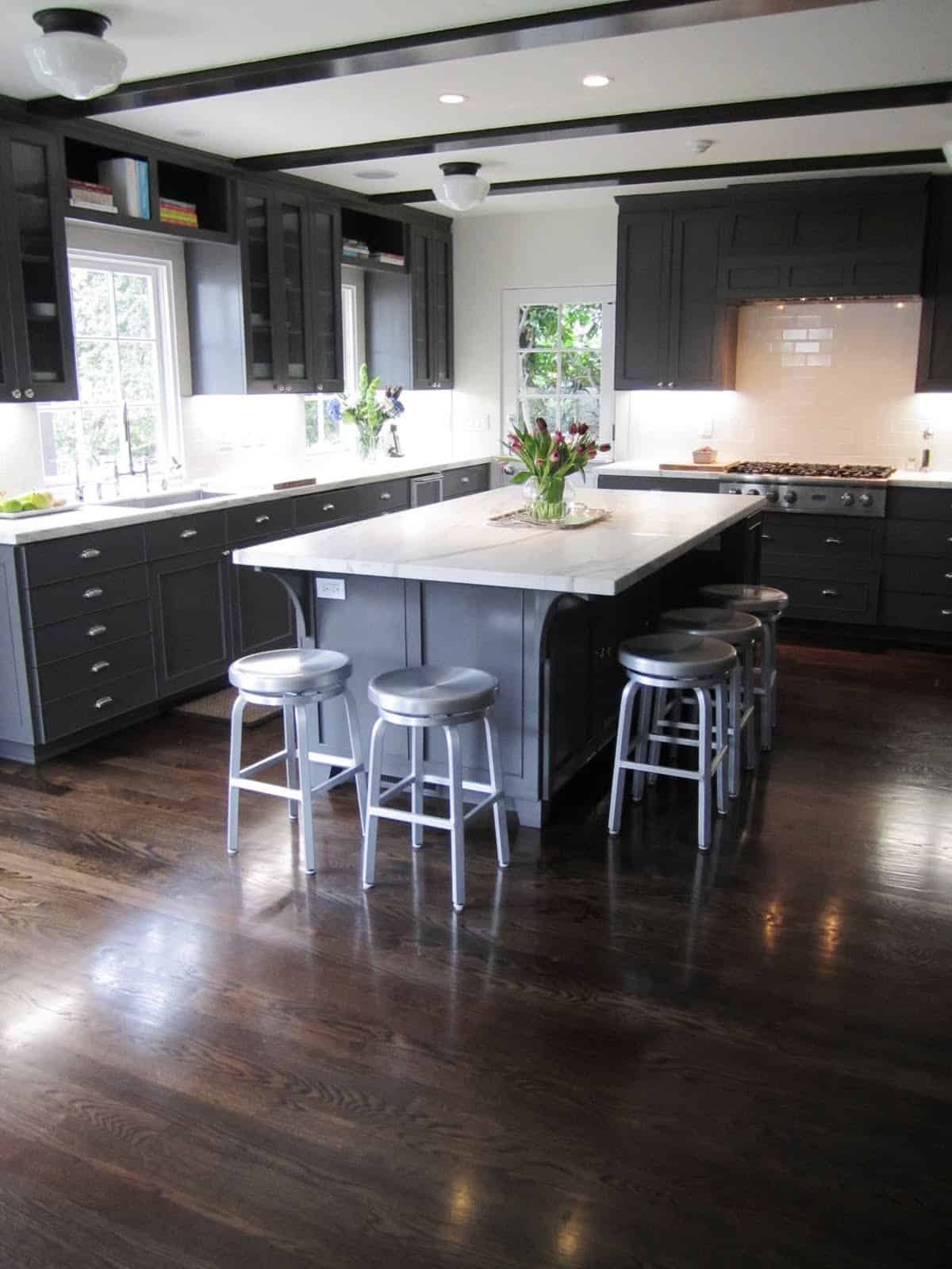 dark charcoal kitchen cabinets with hardwood floors