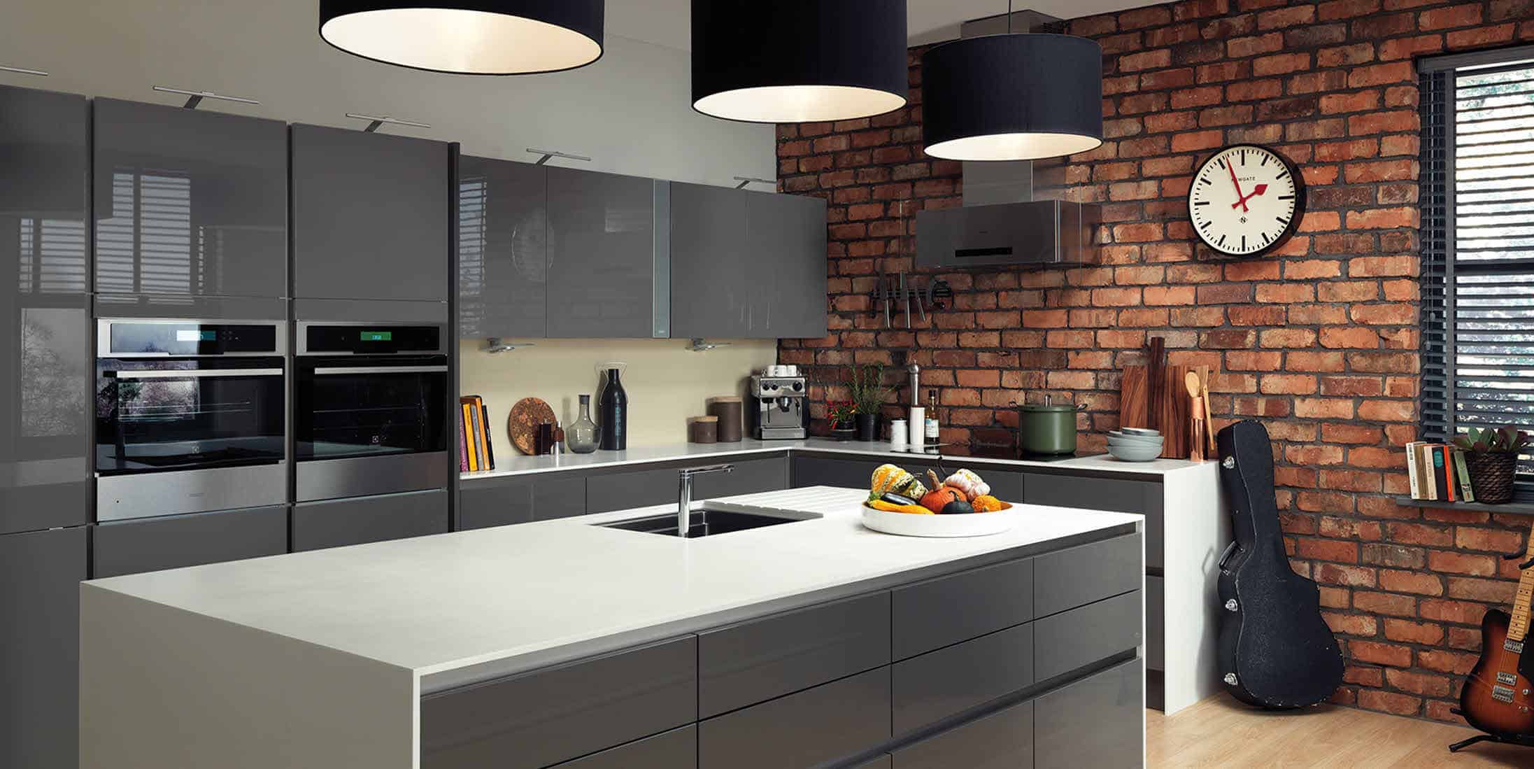 grey kitchen with exposed brick wall