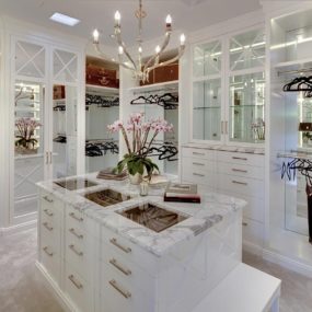 The excellent aspect of having an island inside of your walk-in closet is that it can become an extra storage space.